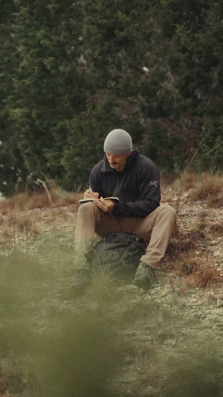 Chris Petkas writing outdoors